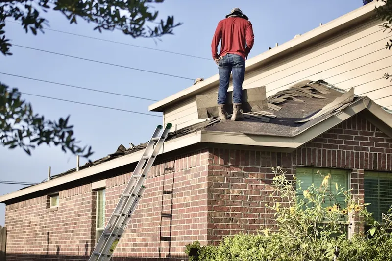 Professional roofer working on a residential roof in Whittier